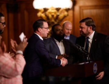 Pennsylvania Gov. Josh Shapiro shakes hands with state Senate Majority Leader Joe Pittman.