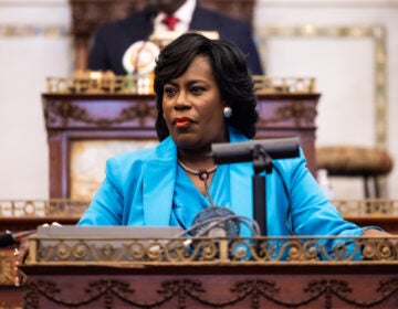 Mayor Cherelle Parker looks on