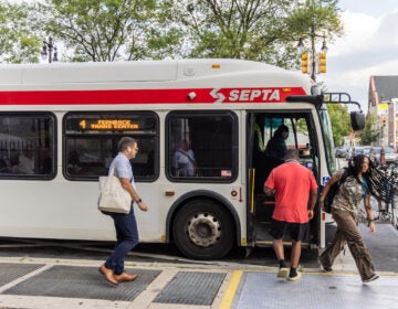 Commuters exit and board the route 4 bus