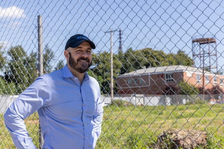 Philip Balderston posing for a photo near the lot that will be developed