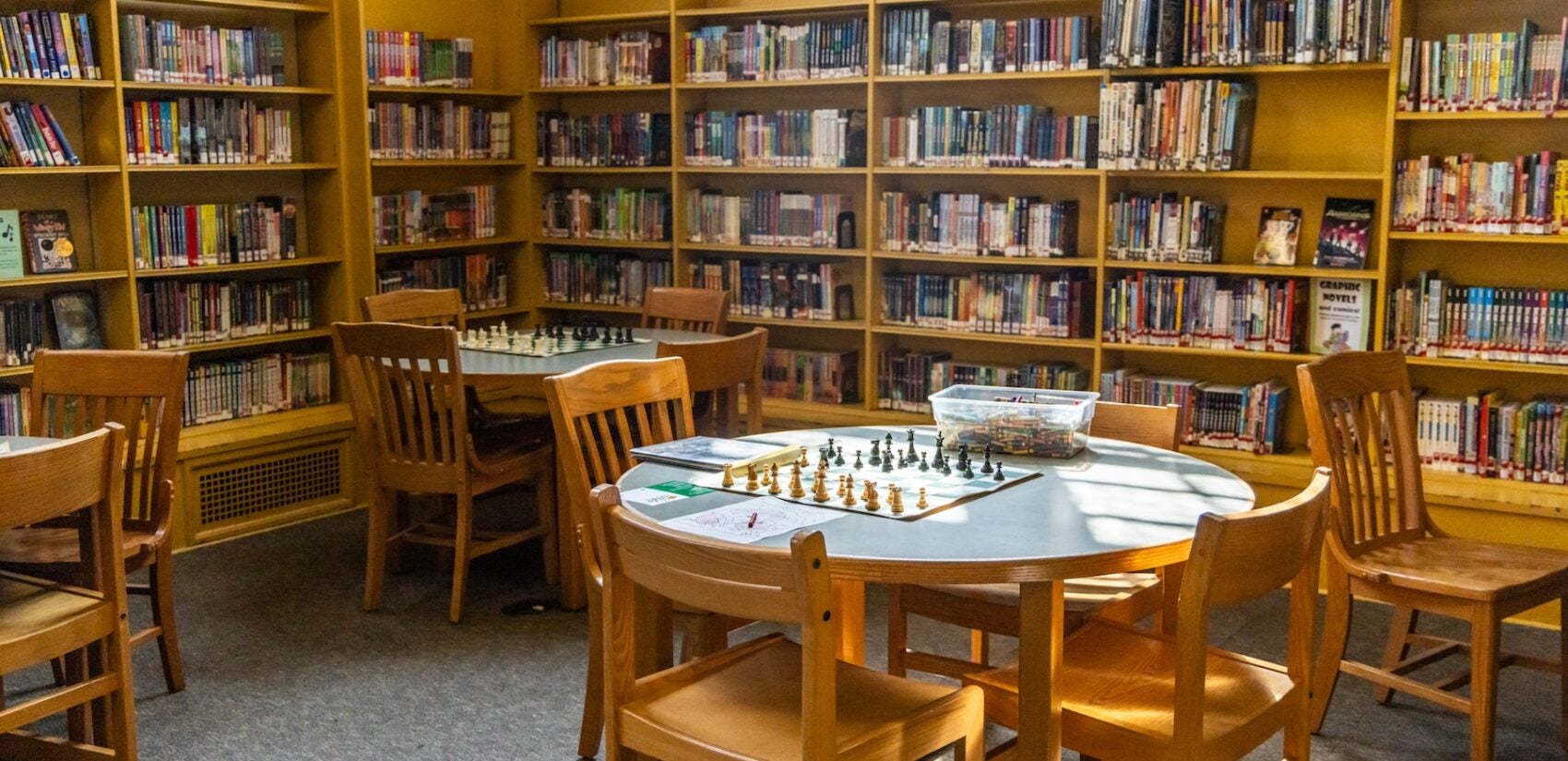 A chess game is set up on a table at Oak Lane Library