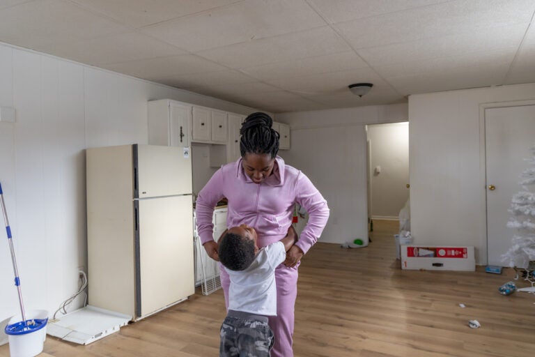 LaChenee Nelson, 24, hugs her son, Logan, 5, in their apartment