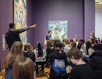 Students listen to a speaker in the museum