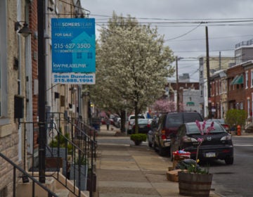 A for sale sign is visible on a street in Fishtown, Philadelphia.