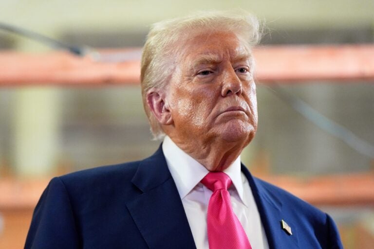 President Donald Trump looks on