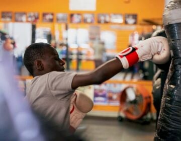 Aaron Geddes punching a heavy bag