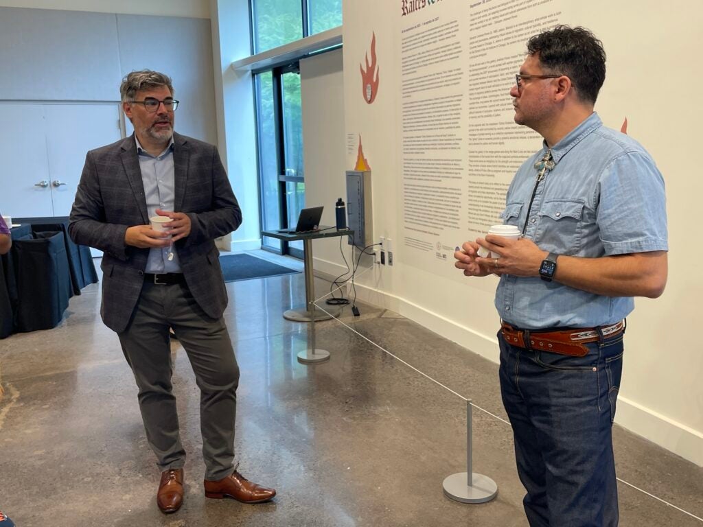 Salvador Jiménez-Flores standing and talking with Gary Garrido Schneider