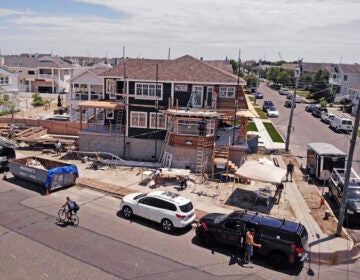 In this image from a drone, workers construct a new house elevated with cinder blocks in Stone Harbor, New Jersey, on Thursday, July 23, 2020. (AP Photo/Ted Shaffrey)