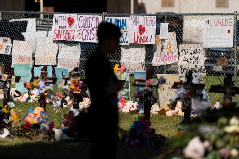 A woman visits a memorial honoring the victims killed in elementary school shooting in Uvalde, Texas, Friday, June 3, 2022. (AP Photo/Jae C. Hong)