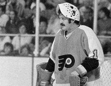 Philadelphia Flyers goalie Bernie Parent raises his mask