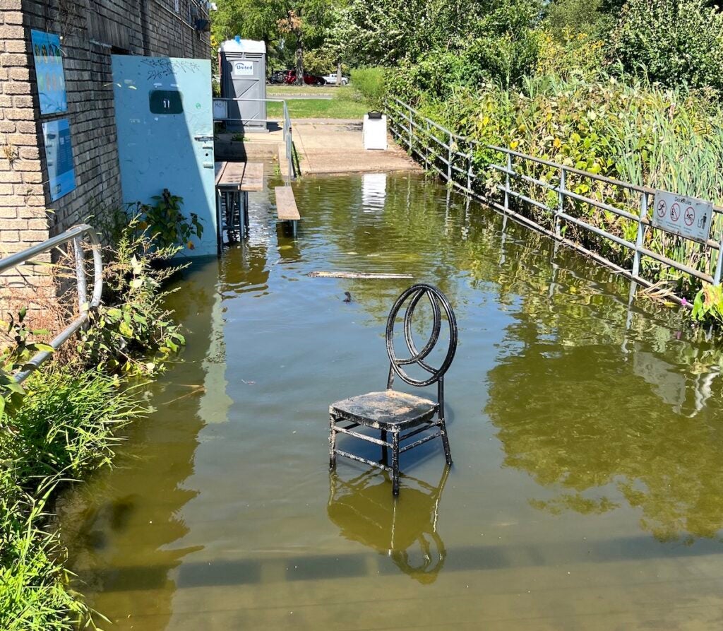 Chair outside flooded boathouse