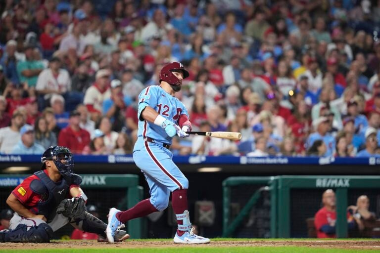 Kyle Schwarber watches after hitting a two-run home run