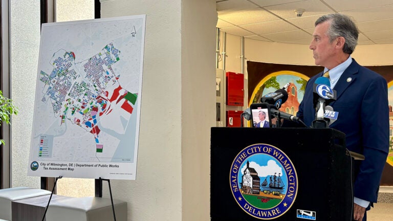 Wilmington Mayor John Carney refers to a map where the poorest neighborhoods in the city, in red, were feeling the brunt of property tax hikes