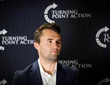 Charlie Kirk looks on