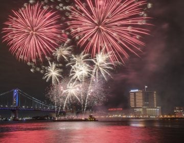 Fireworks are launched from a barge in the Delaware River as seen from Penns Landing.(Jonathan Wilson for WHYY)