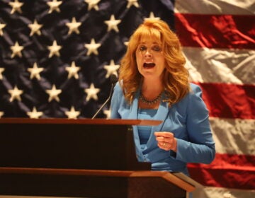 State treasurer Stacy Garrity speaks at the Pennsylvania Republican Party’s fall meeting with an American flag behind her