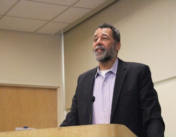 King Downing, lead prosecutor of The People's Tribunal on War Crimes and Genocide in Gaza, stands at a podium