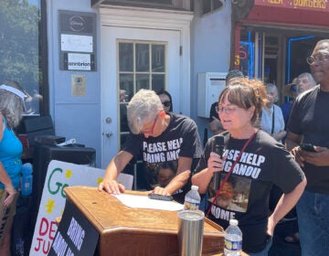 A woman speaks at a rally on behalf of her husband, who is being detained by federal immigration officials