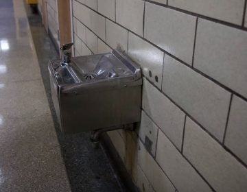 a water fountain in a school hallway