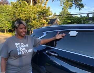 Carolyn Martin gestures toward a sensor on a car