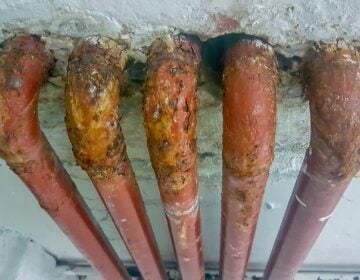 several old lead pipes in a wall