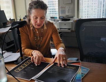 Liz Hersh sitting at a table with papers