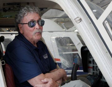 Mark Ciccone sits in a helicopter