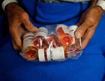 a bag of medications in someone's hands