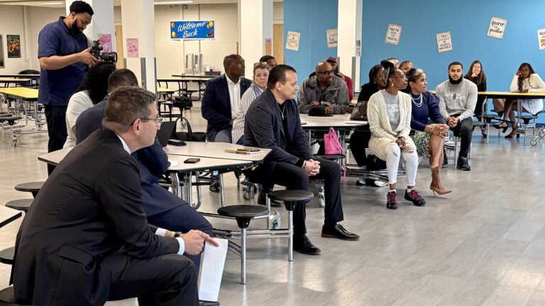 People sit in chairs at a Delaware community listening session about gun violence