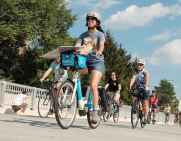 People riding their bikes across the brige