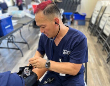 Emergency medicine physician Kenny Banh measures a patient’s blood pressure. (Courtesy of UCSF Fresno)