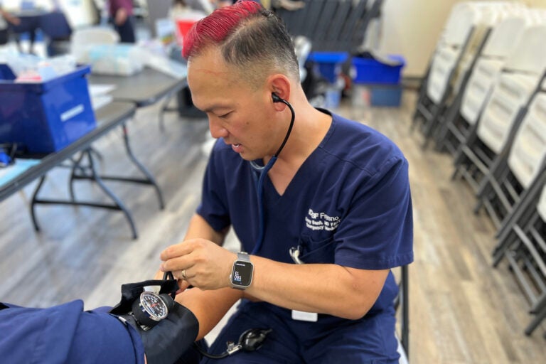 Emergency medicine physician Kenny Banh measures a patient’s blood pressure. (Courtesy of UCSF Fresno)