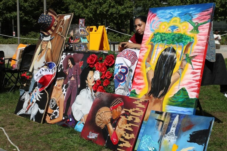 an artist selling multiple painting