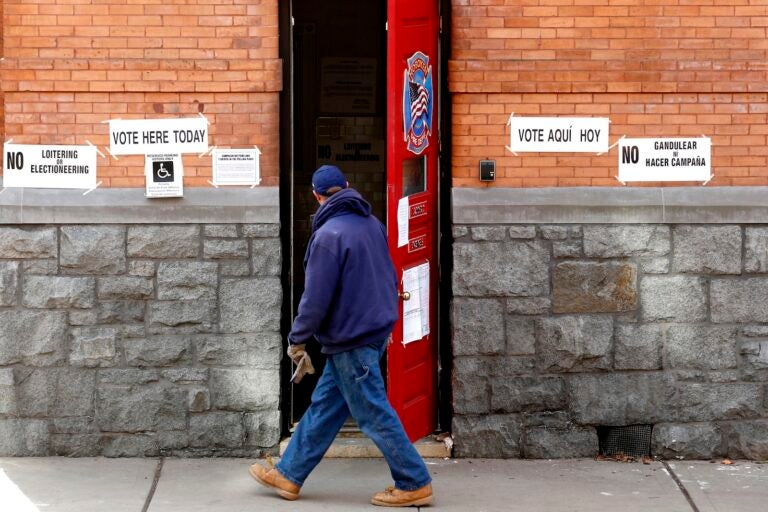 A man walks into a polling place at a Hoboken Fire Department firehouse during Election Day