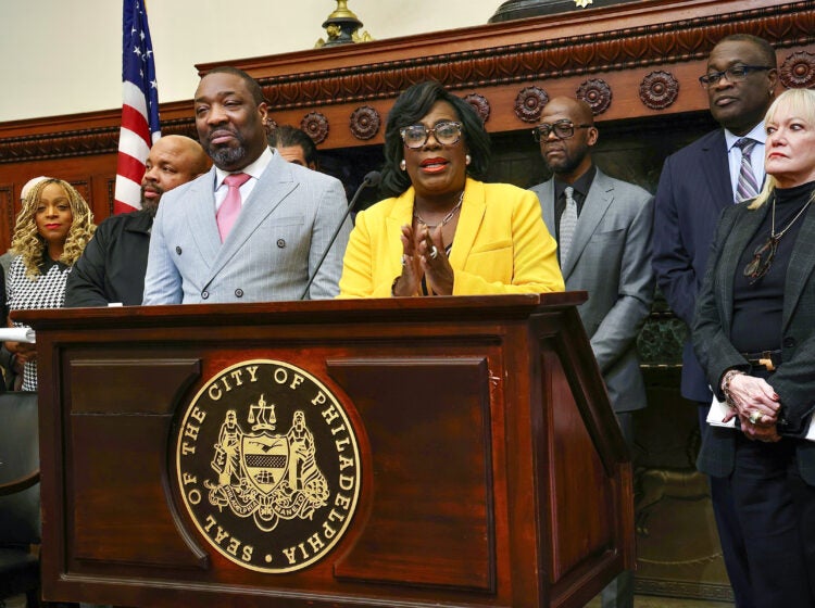 Cherelle Parker speaking at a podium surrounded by other officials