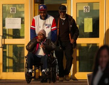Liza Fortt, 74 (center), accompanied by her son Timothy Walker (center top), and husband Willie Fortt emerge from their polling place at Scranton High School on Election Day, Nov. 5, 2024.