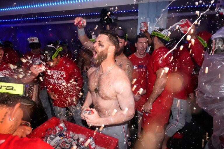 Philadelphia Phillies' Bryce Harper, center, celebrates after the Phillies clinched the NL East following their defeat of the Los Angeles Dodgers Monday, Sept. 15, 2025, in Los Angeles.
