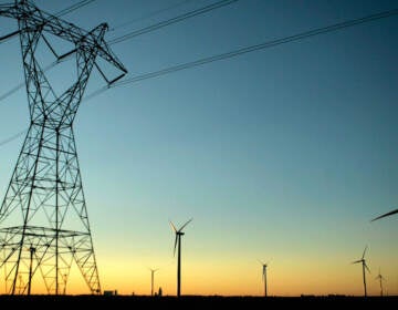 High-voltage electric transmission lines pass through a wind farm.