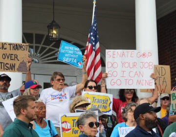 rallygoers in North Wales hold signs about SEPTA finding