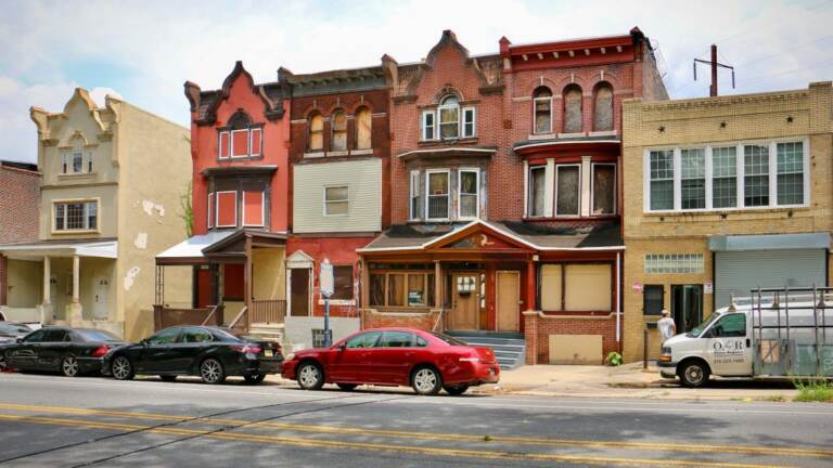 Rowhomes are shown from across the street.