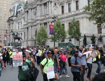 Union members and supporters marched around City Hall