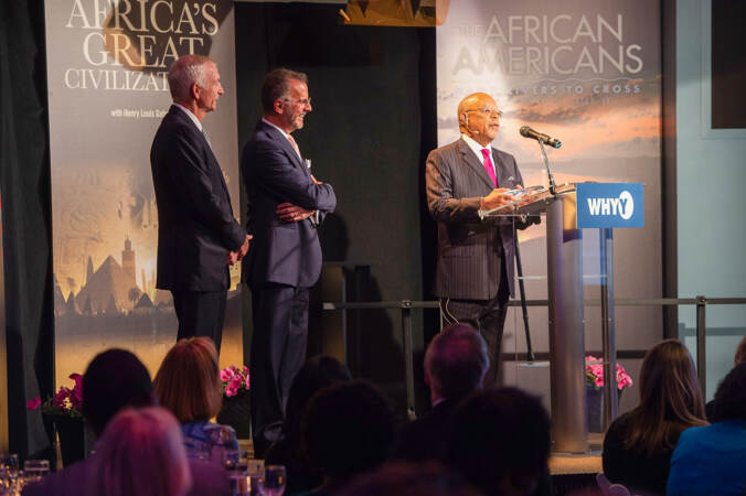 Henry Louis Gates Jr. at a WHYY podium giving a speech