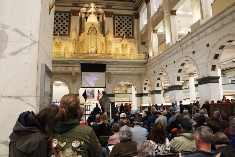 A large crowd is gathered to listen to an organ concert in Philadelphia
