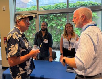 two reporters and an attendee at the WHYY open house event