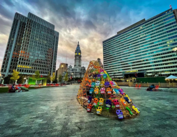 A colorful sculpture with skulls in LOVE Park