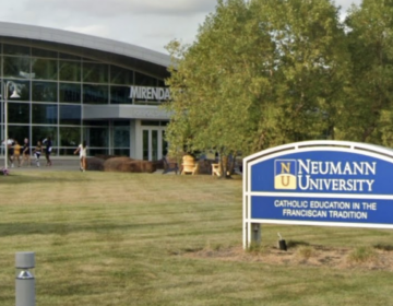 A sign welcomes people to Neumann University campus